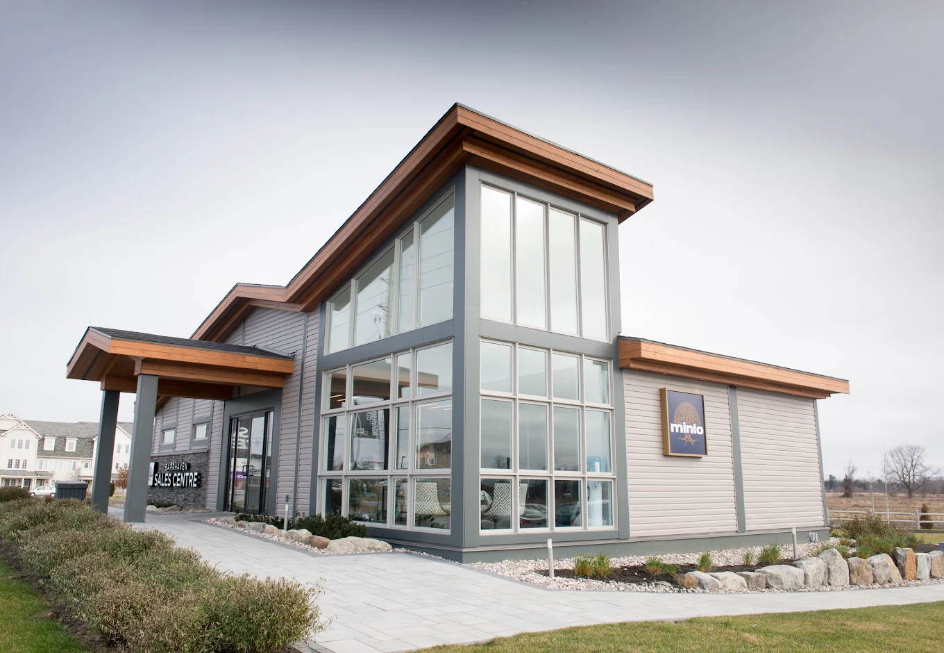 Minto Communities sales centre in Ottawa — modern architecture with cedar accents and floor-to-ceiling windows